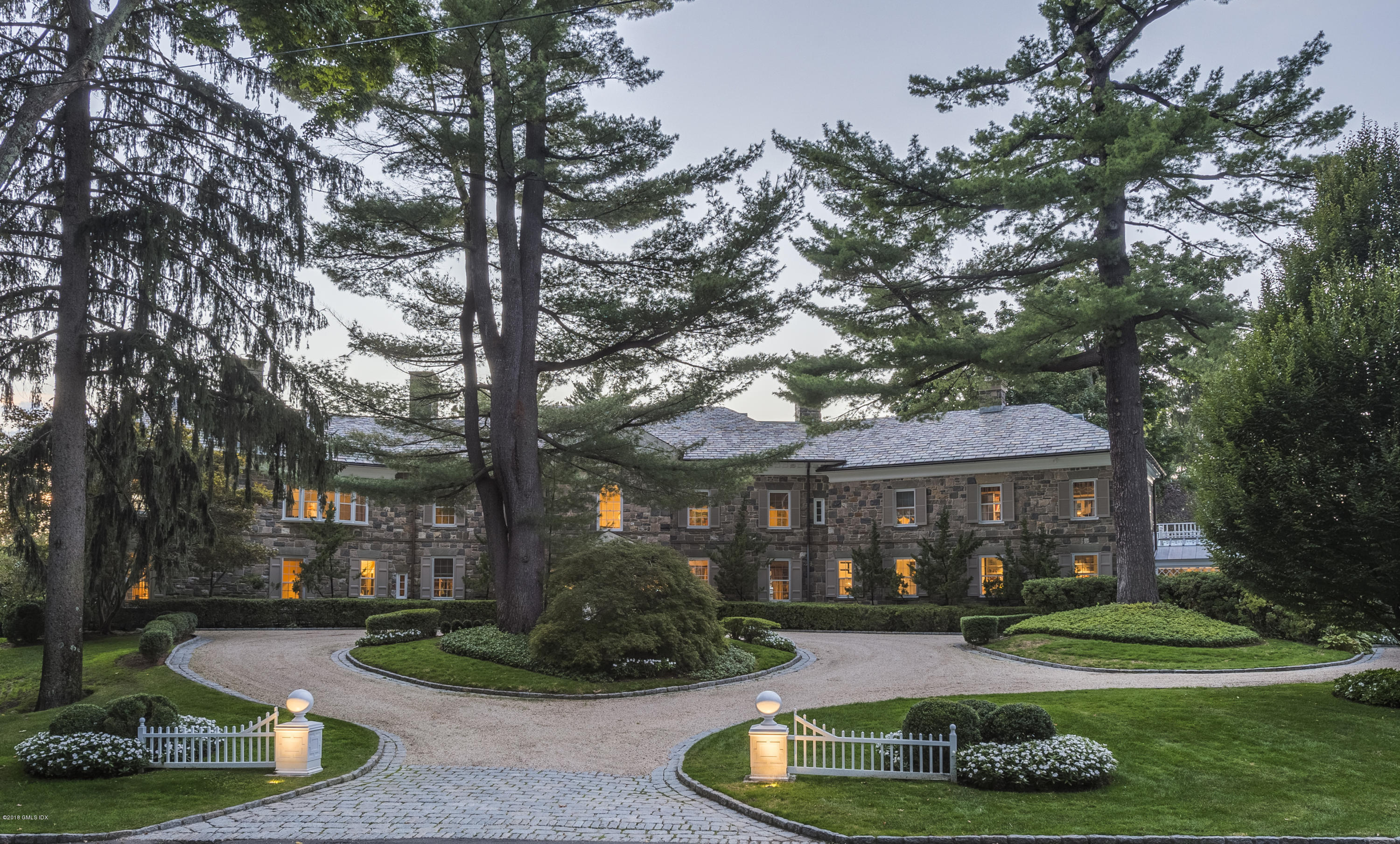16 Rock Ridge Avenue Greenwich, CT 06831 - Photo 5 of 57 a front view of a house with yard and green space