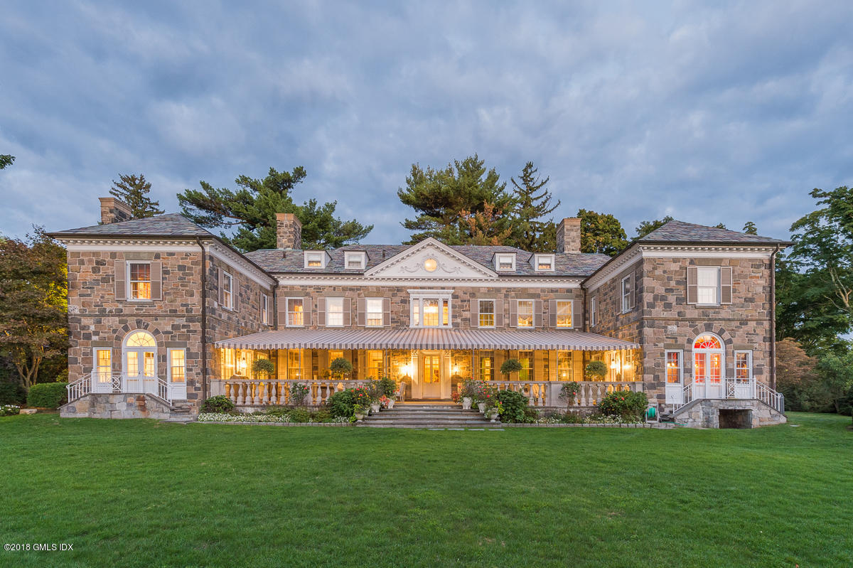 16 Rock Ridge Avenue Greenwich, CT 06831 - Photo 7 of 57 a large building with a big yard and potted plants in front of it