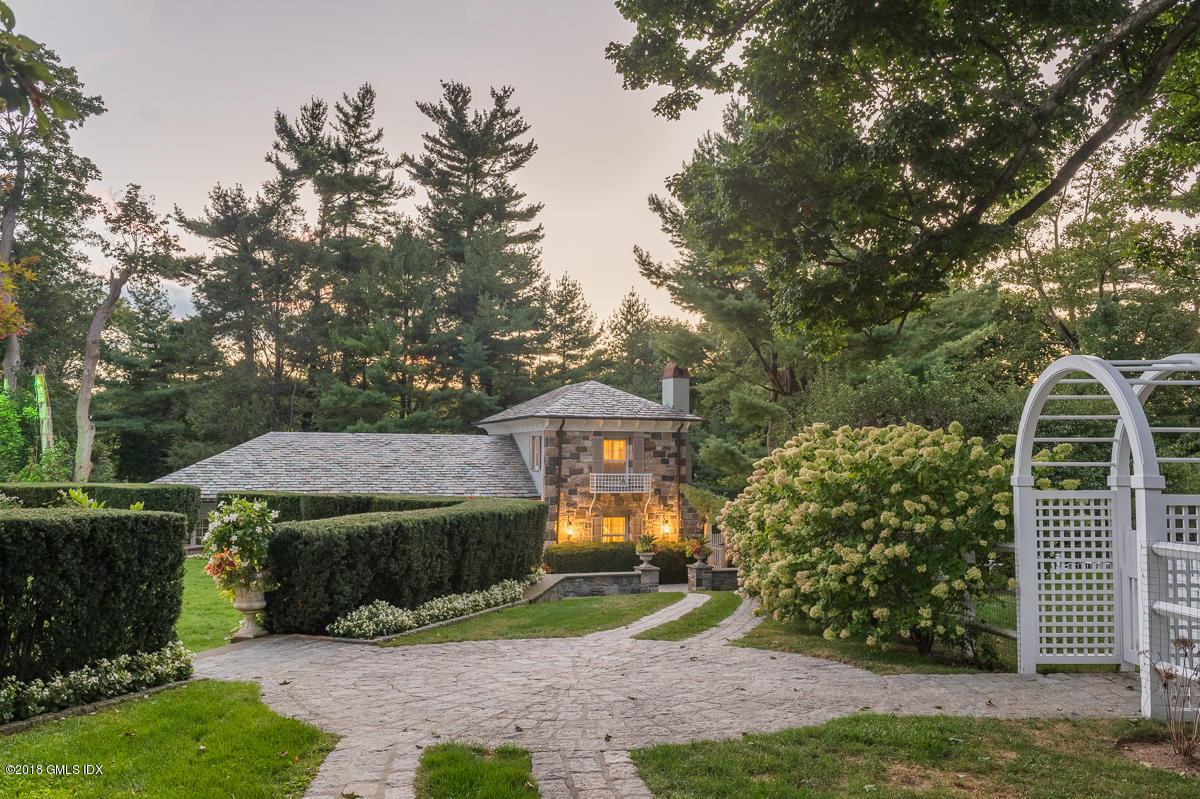 16 Rock Ridge Avenue Greenwich, CT 06831 - Photo 9 of 57 a front view of a house with a yard and shrubs