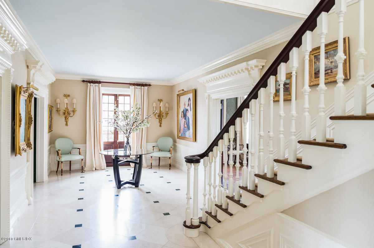 16 Rock Ridge Avenue Greenwich, CT 06831 - Photo 10 of 57 a view of staircase with lots of white furniture and a chandelier