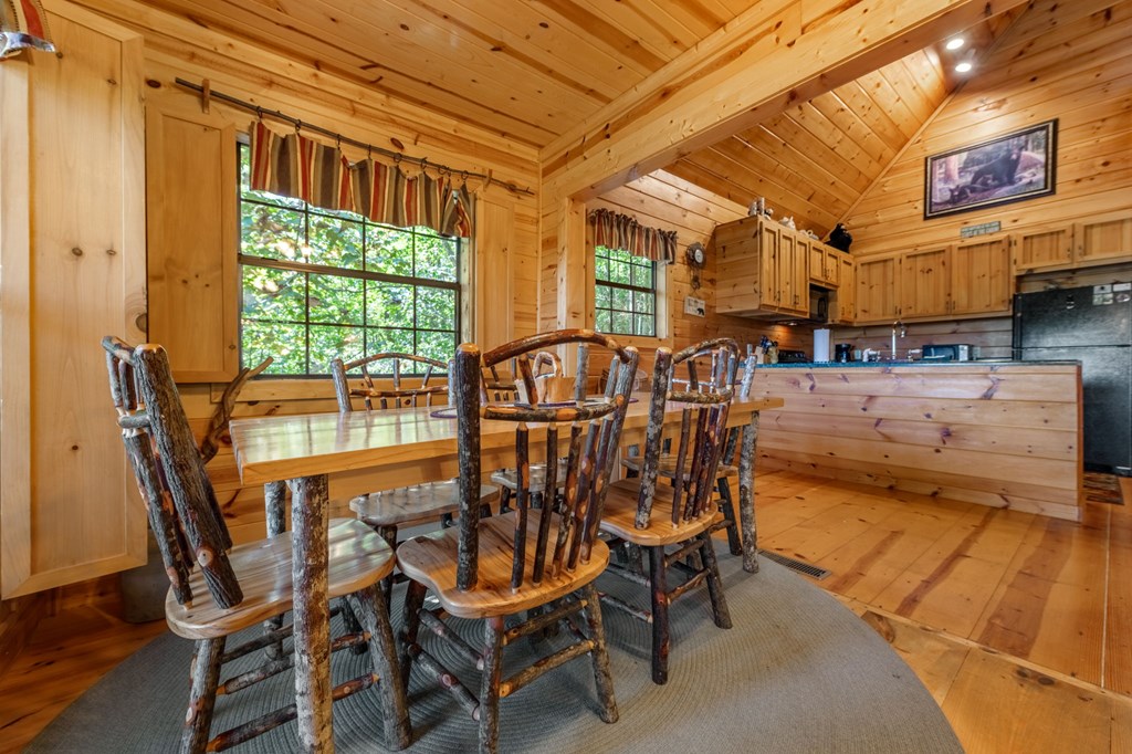 293 Broken Arrow Path Blue Ridge, GA 30513 - Photo 12 of 48 a view of a dining room with furniture and a floor to ceiling window