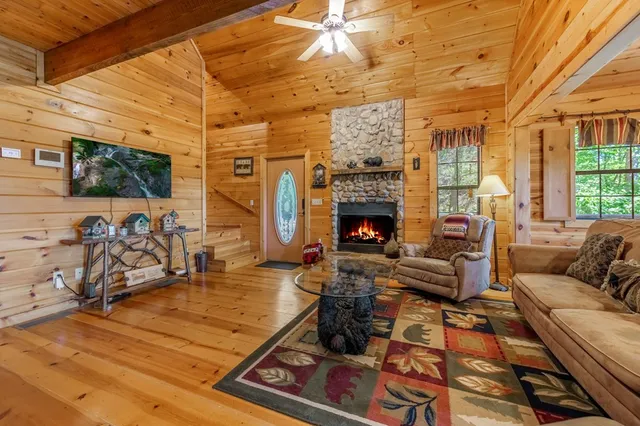 a living room with furniture a flat screen tv and a fireplace