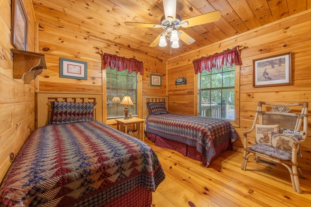 293 Broken Arrow Path Blue Ridge, GA 30513 - Photo 17 of 48 a spacious bedroom with a bed and a table