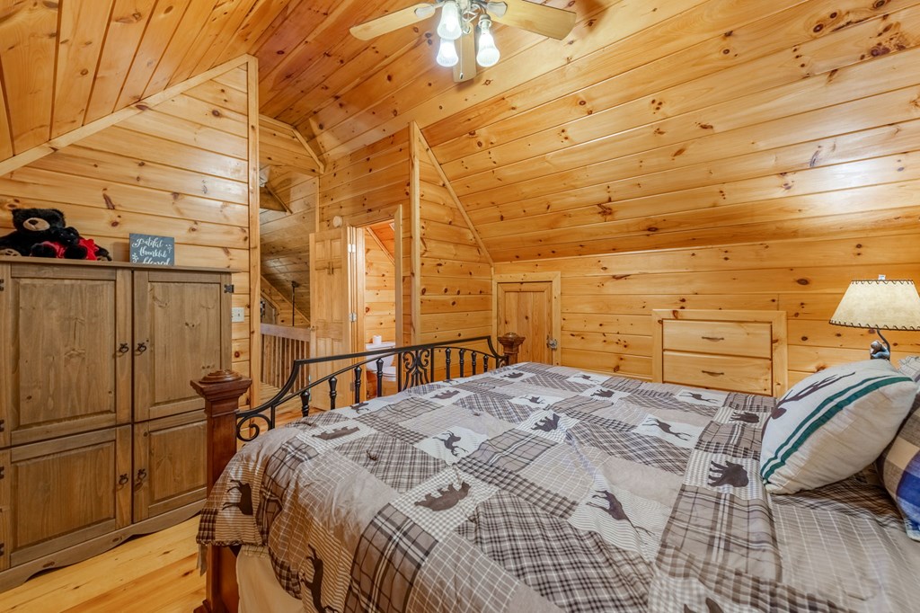 293 Broken Arrow Path Blue Ridge, GA 30513 - Photo 22 of 48 a bedroom with a bed and a table