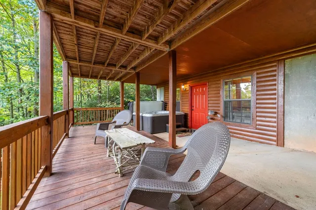 a view of a house with a yard and wooden fence