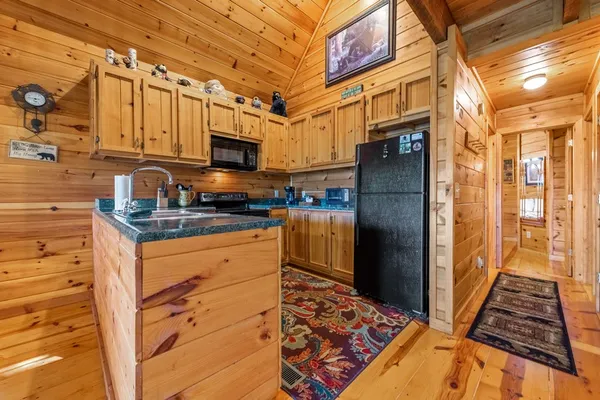 a kitchen with stainless steel appliances granite countertop a refrigerator and a stove