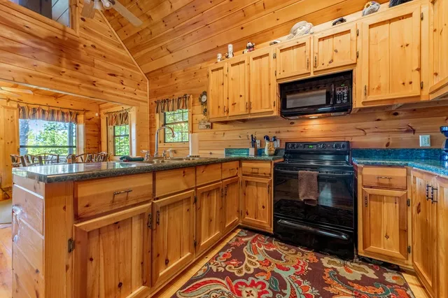 a kitchen with stainless steel appliances a stove and a microwave