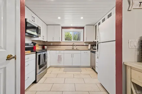 a kitchen with a stove sink and refrigerator