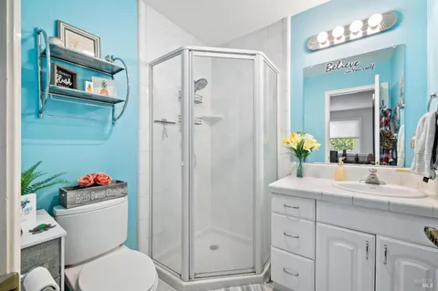 a bathroom with a sink vanity mirror and toilet
