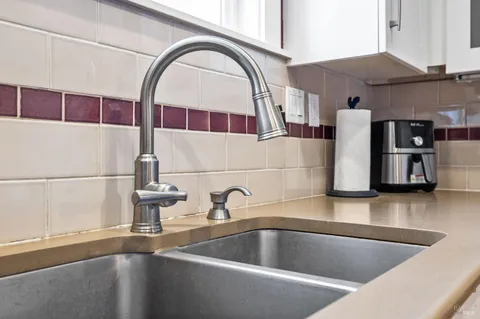 a kitchen with a sink and a large window