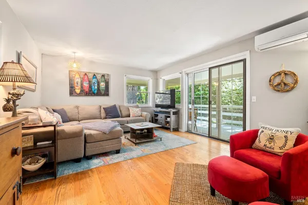 a living room with furniture a fireplace and a large window