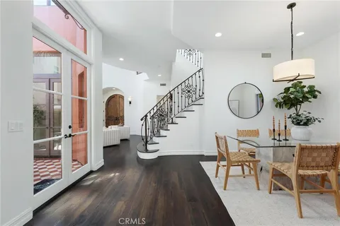 a living room with furniture and paintings on the wall
