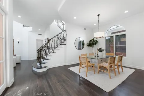 a living room with furniture white walls and kitchen view
