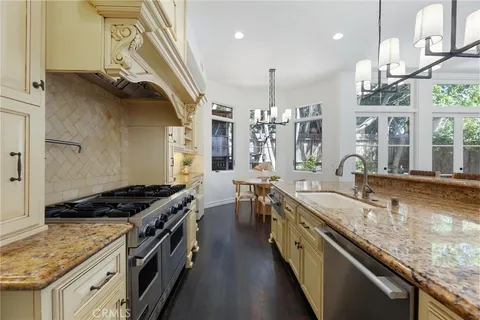 a bathroom with a granite countertop sink a toilet and a mirror