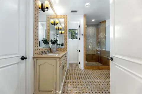 a bathroom with a granite countertop sink a toilet and mirror