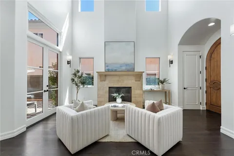 a dining room with furniture a potted plant and wooden floor