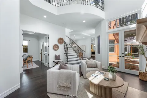 a view of a dining room with furniture wooden floor and chandelier