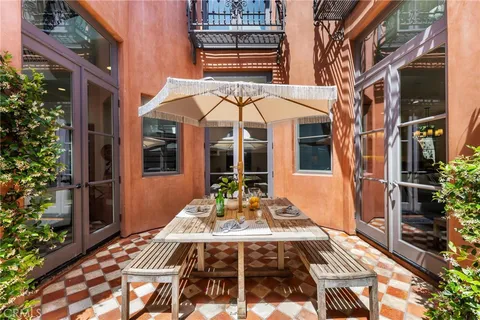 a dining room with wooden floor a glass table and chairs