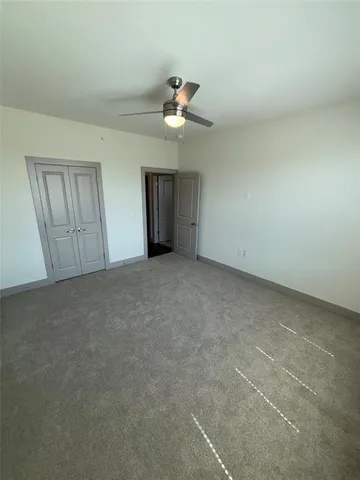 a view of empty room with ceiling fan