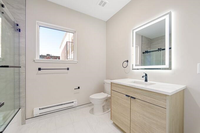 304 61st Street, Unit 3A West New York, NJ 07093 - Photo 23 of 44 a bathroom with a toilet sink and mirror