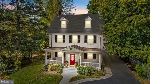 a view of an entryway with wooden floor and door