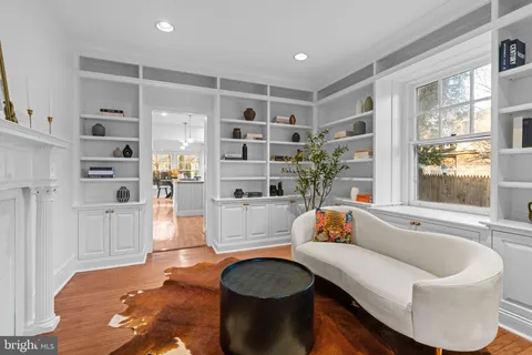 a view of a dining room with furniture a chandelier and wooden floor