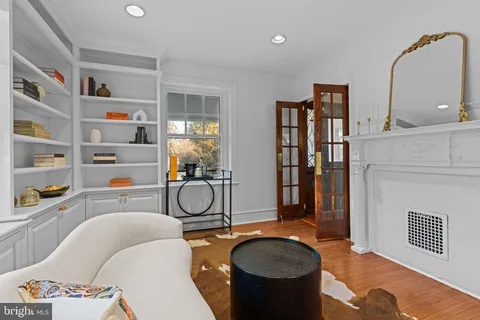 a kitchen with stainless steel appliances granite countertop a refrigerator a stove top oven a sink dishwasher and white cabinets with wooden floor