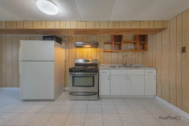 a kitchen with a refrigerator and cabinets