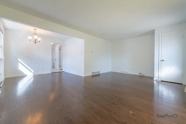 an empty room with wooden floor