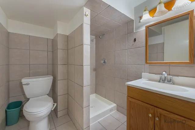 a bathroom with a toilet sink and shower