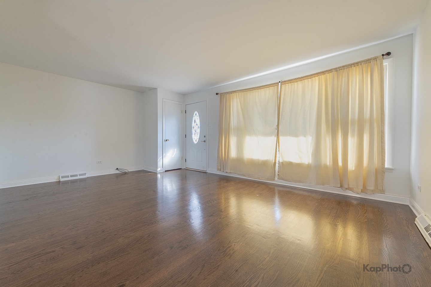3704 West 57th Street Chicago, IL 60629 - Photo 4 of 30 a view of an empty room with wooden floor and a window