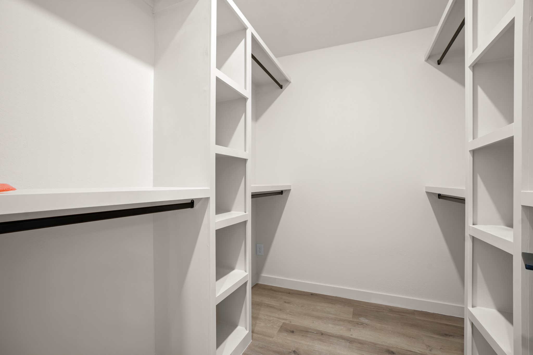 7826 Wheel Rim Circle Austin, TX 78749 - Photo 14 of 38 Custom built-in shelving and ample hanging rods maximize organization in this modern walk-in closet.