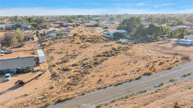 a view of a dry yard with a house