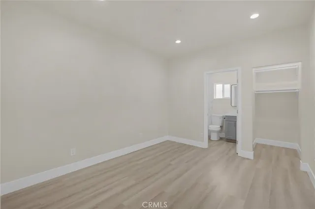 a view of a room with wooden floor and a window