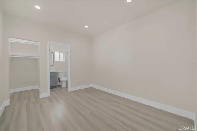 a view of a room with wooden floor