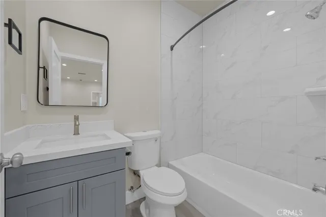 a bathroom with a toilet a sink and a bathtub