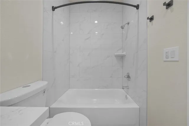 a bathroom with a bathtub and a toilet