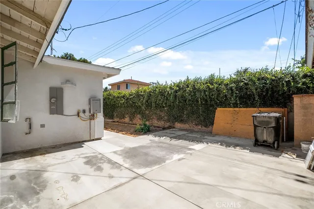a backyard of a house with yard and outdoor seating