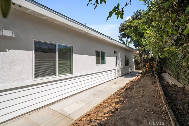 a view of a house with backyard and trees