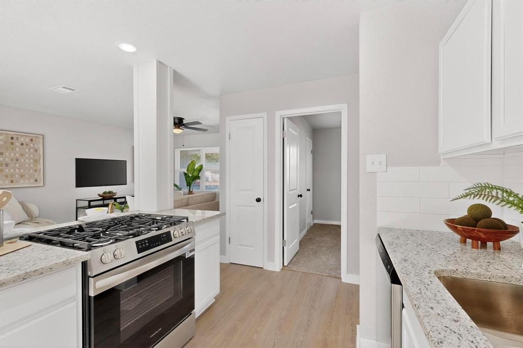 5808 Hanson Drive Watauga, TX 76148 - Photo 11 of 33 a kitchen with granite countertop a stove and a sink
