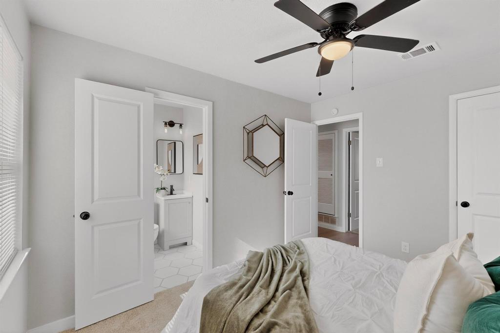 5808 Hanson Drive Watauga, TX 76148 - Photo 17 of 33 a bedroom with a bed and a chandelier