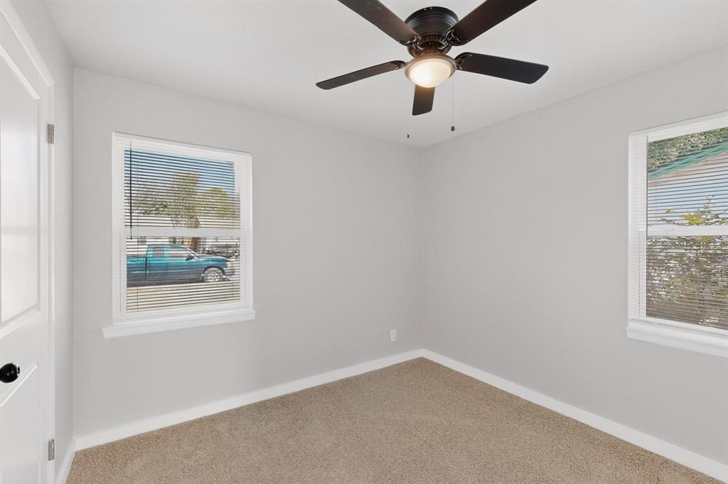 5808 Hanson Drive Watauga, TX 76148 - Photo 22 of 33 an empty room with a window and a fan