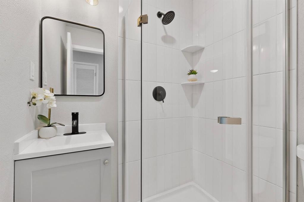 5808 Hanson Drive Watauga, TX 76148 - Photo 26 of 33 a bathroom with a shower and mirror