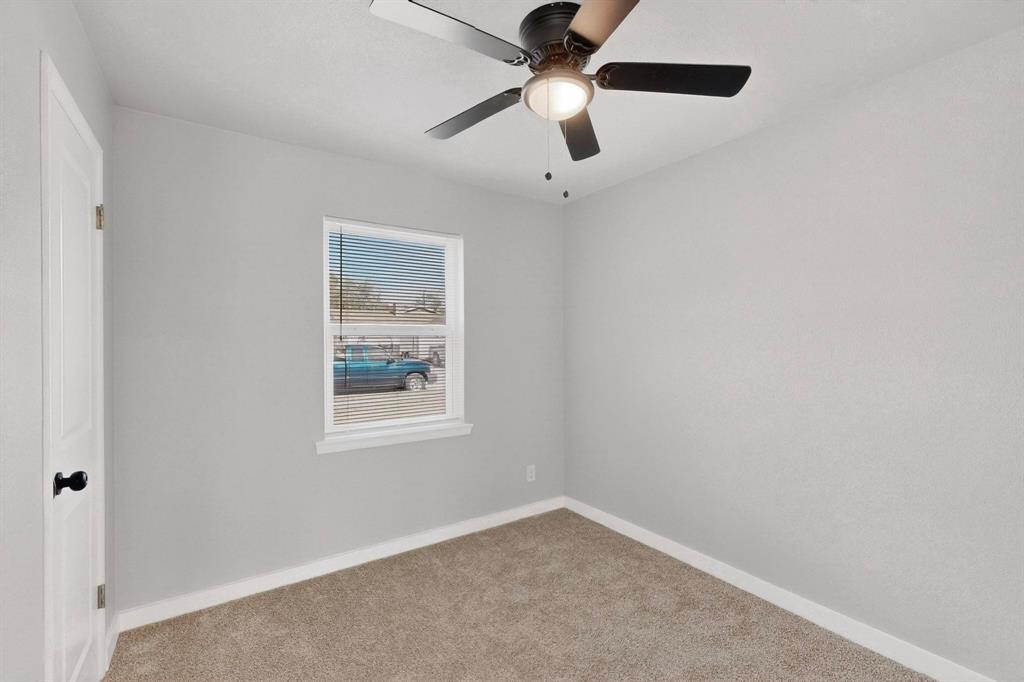 5808 Hanson Drive Watauga, TX 76148 - Photo 28 of 33 an empty room with a window and a fan
