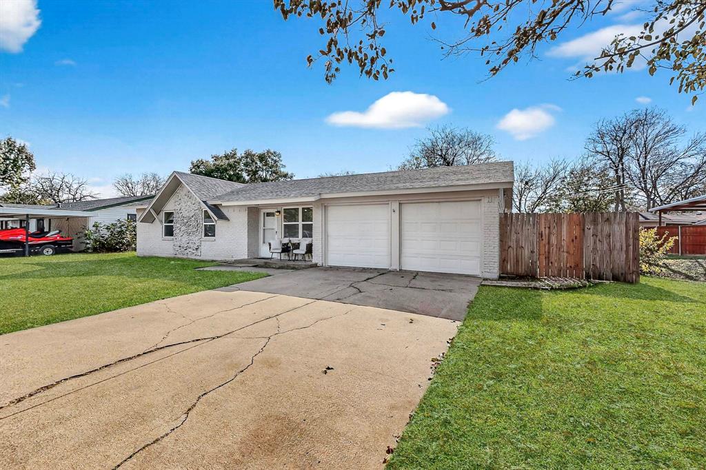 5808 Hanson Drive Watauga, TX 76148 - Photo 3 of 33 a view of house with backyard and a garden