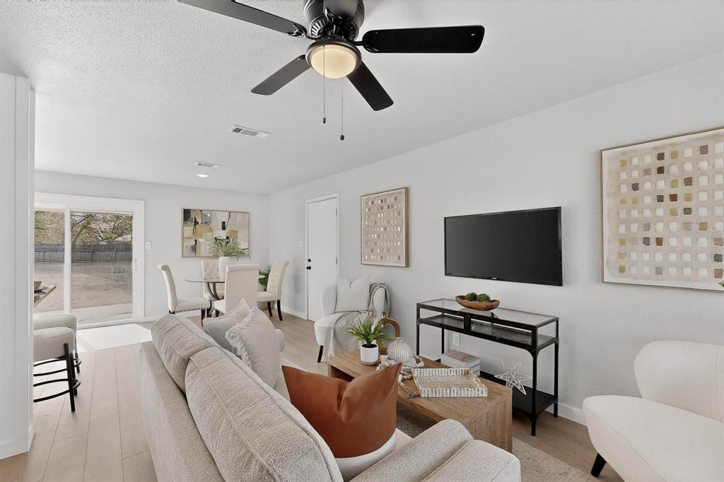 5808 Hanson Drive Watauga, TX 76148 - Photo 6 of 33 a living room with furniture a ceiling fan and a window
