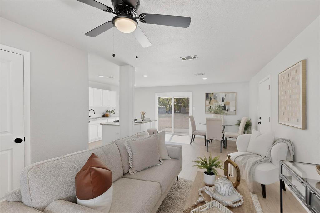 5808 Hanson Drive Watauga, TX 76148 - Photo 7 of 33 a living room with furniture potted plant and a chandelier