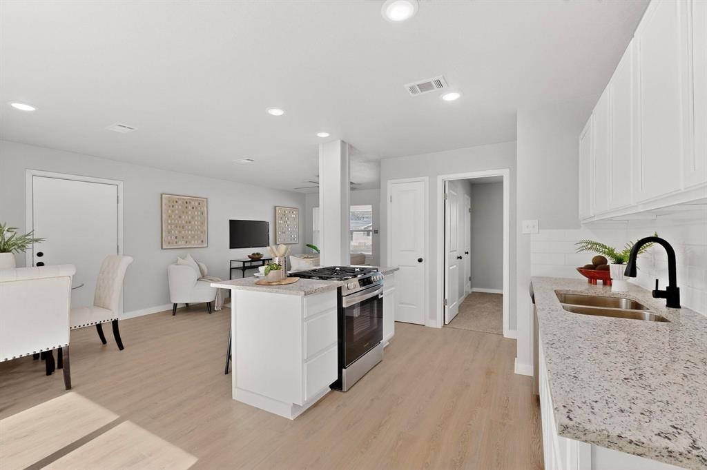 5808 Hanson Drive Watauga, TX 76148 - Photo 9 of 33 a kitchen with sink a stove and refrigerator