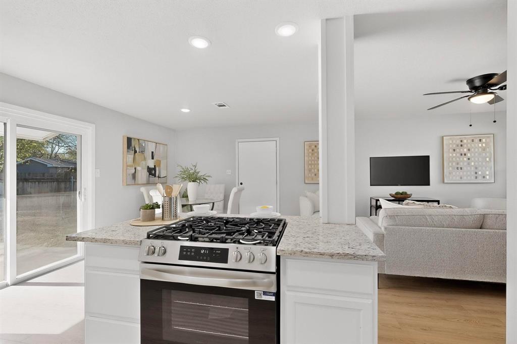 5808 Hanson Drive Watauga, TX 76148 - Photo 10 of 33 a kitchen with stainless steel appliances granite countertop a stove and a sink