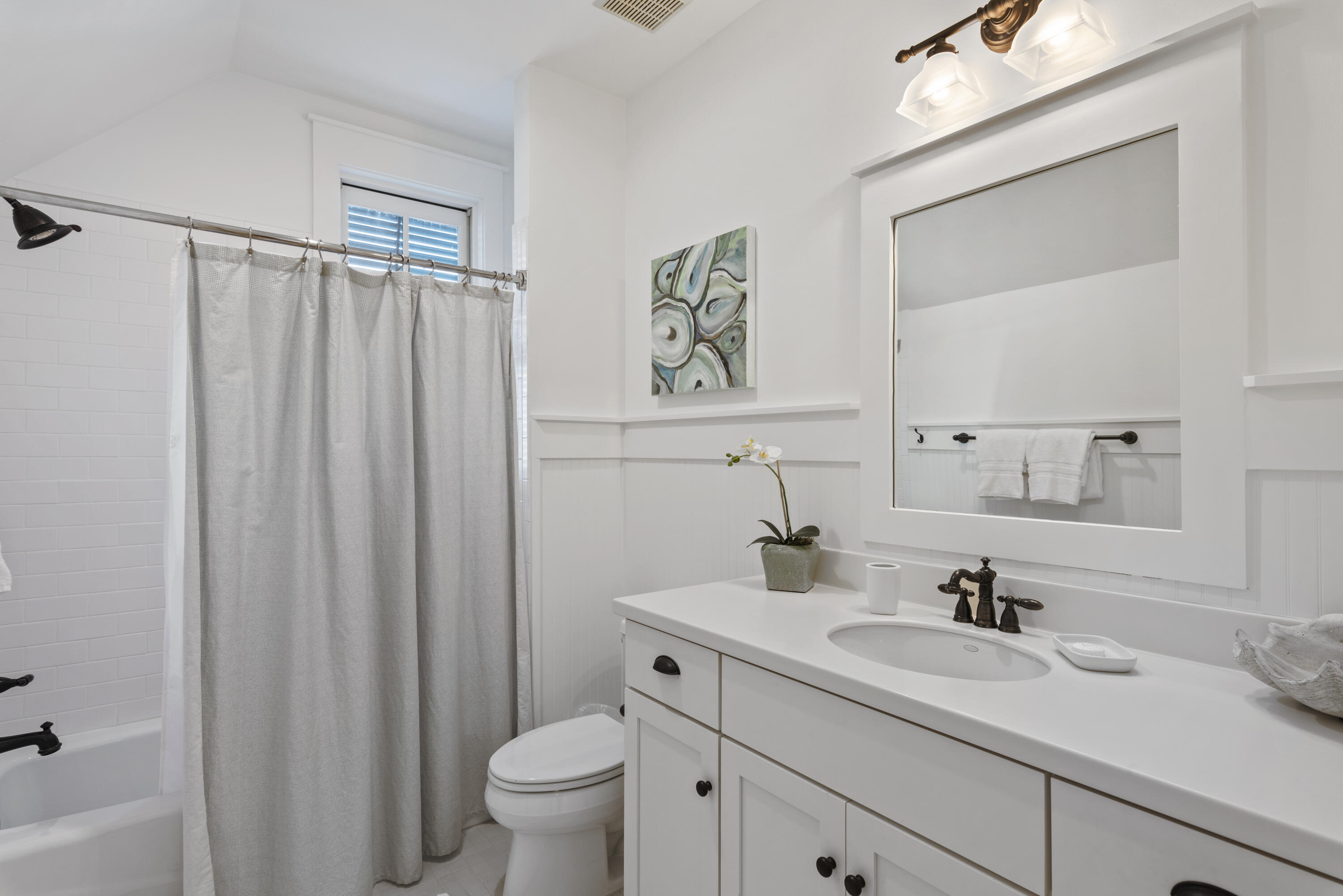 250 Needlerush Drive Santa Rosa Beach, FL 32459 - Photo 22 of 29 a bathroom with a granite countertop sink toilet and a mirror